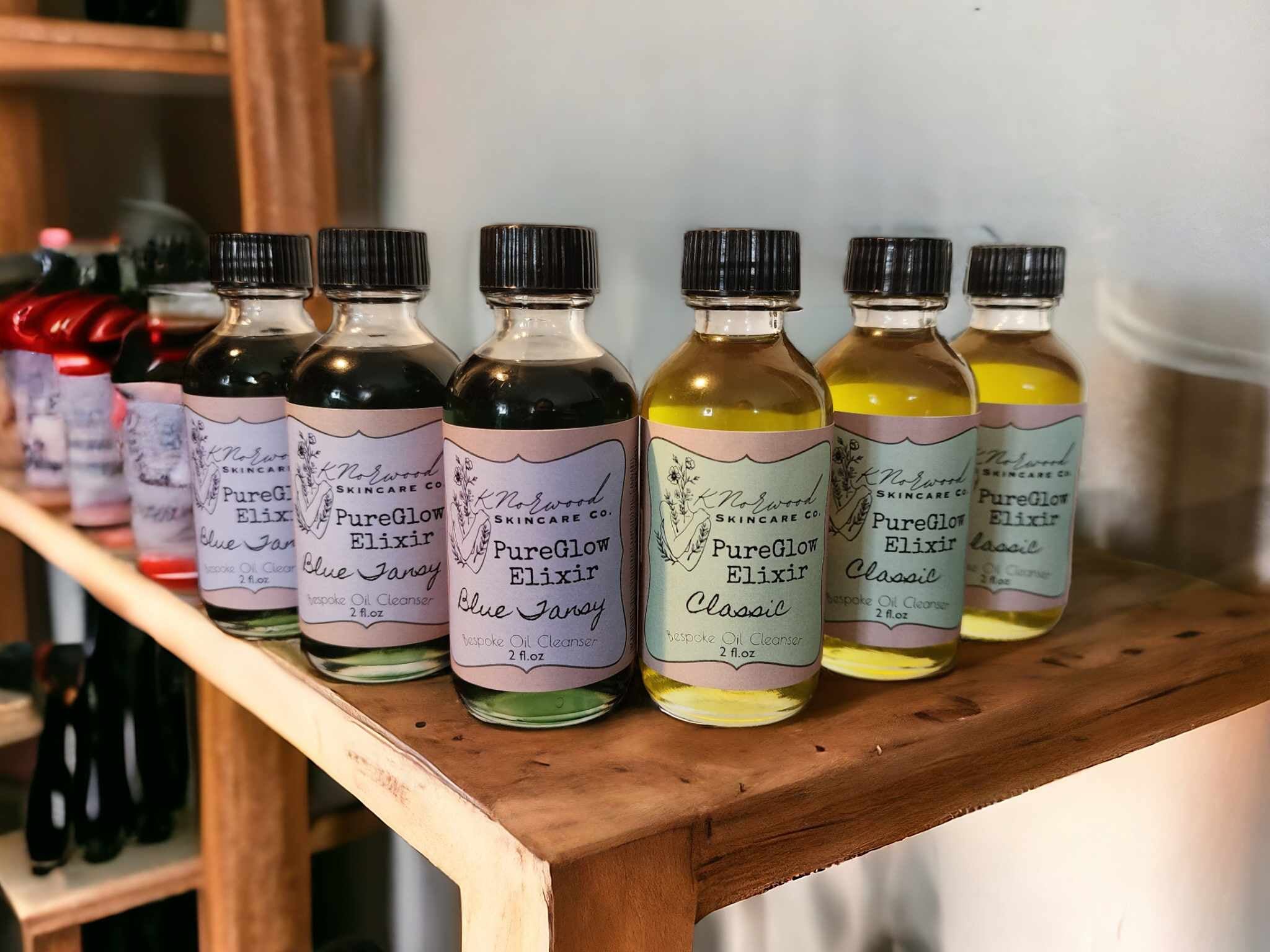 PureGlow Elixir Bottles sitting on a wooden shelf