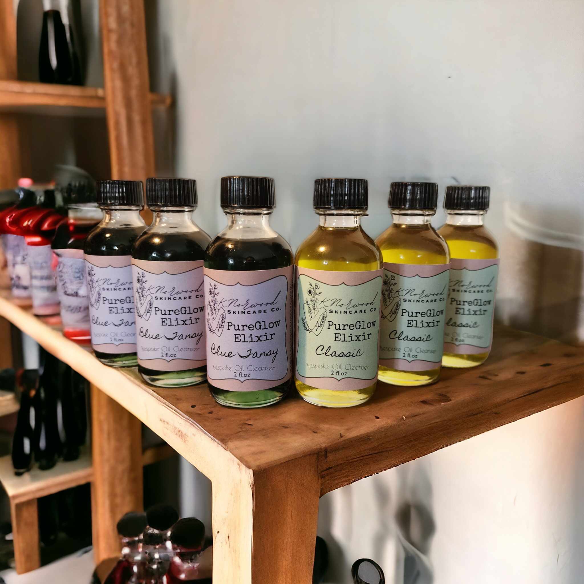PureGlow Elixir Bottles sitting on a wooden shelf
